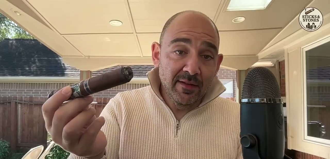 The host of the Sticks & Stones CRE podcast with a cigar